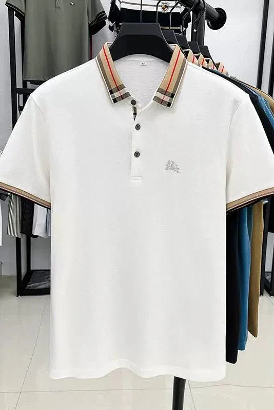 White polo shirt with plaid collar on a hanger against a clothing store background