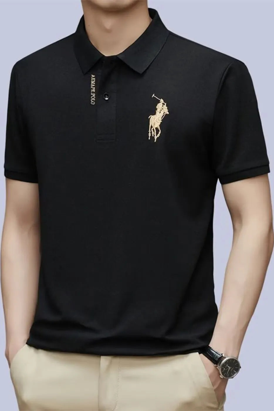 Black polo shirt with a gold logo on a light gray background