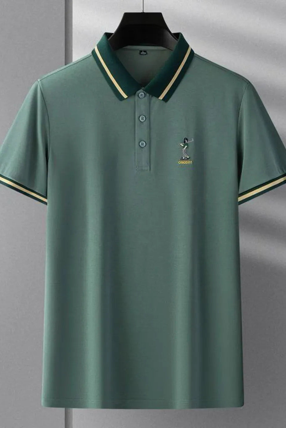 Green polo shirt with a small logo on a gray background
