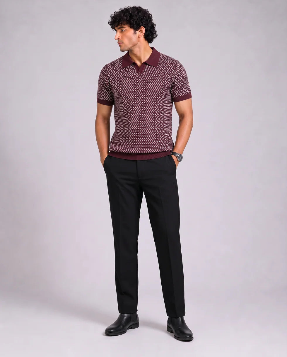 Full-length front view of a model wearing the wine and cream zigzag wave jacquard polo
