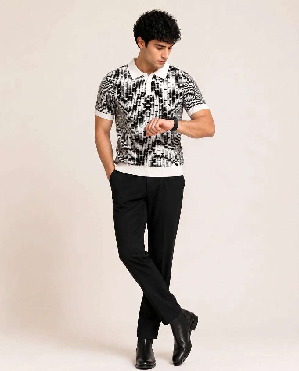 Full-length front view of a model wearing the black and white geometric maze jacquard polo