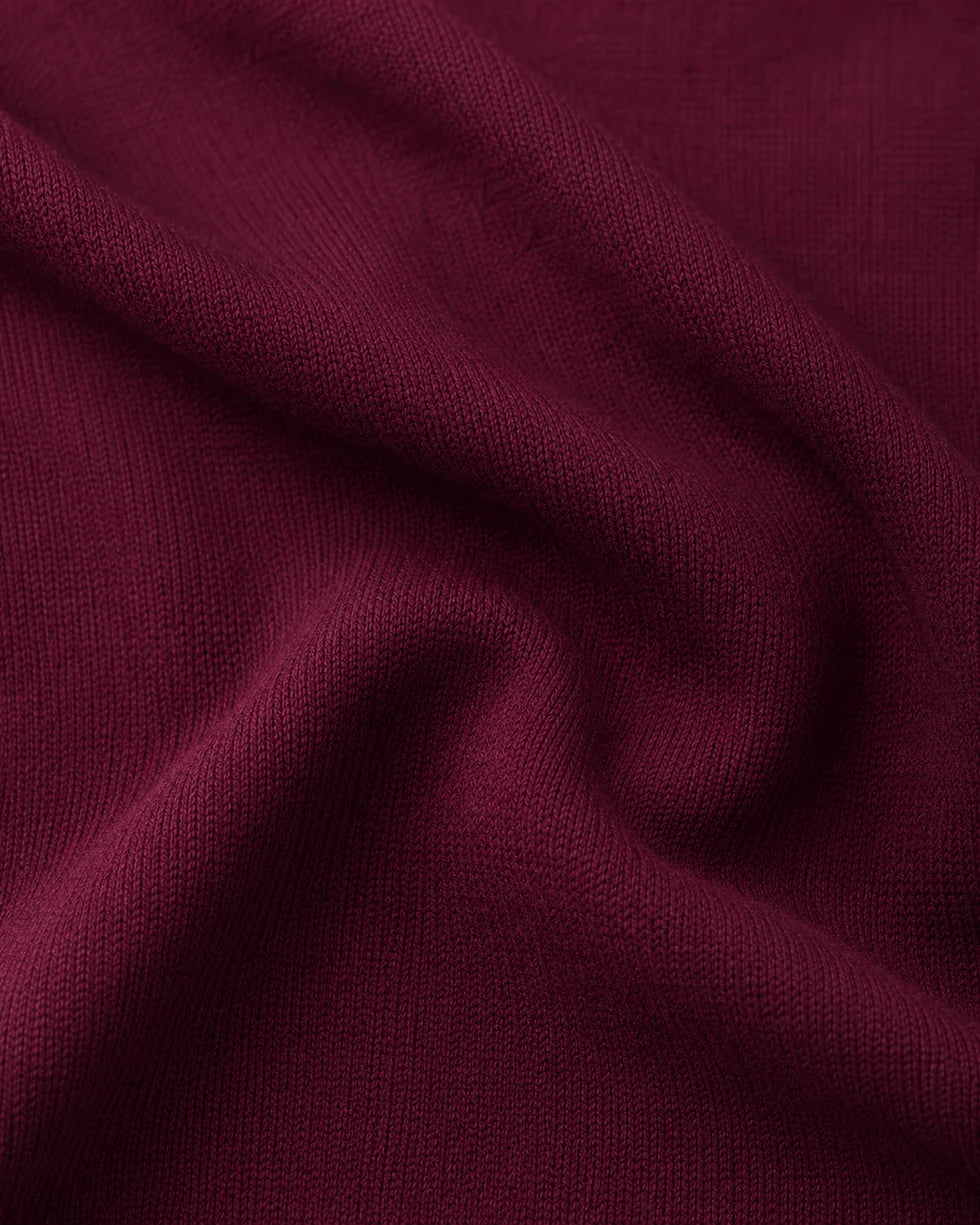 Close-up of the maroon and white colourblock knit polo knit texture