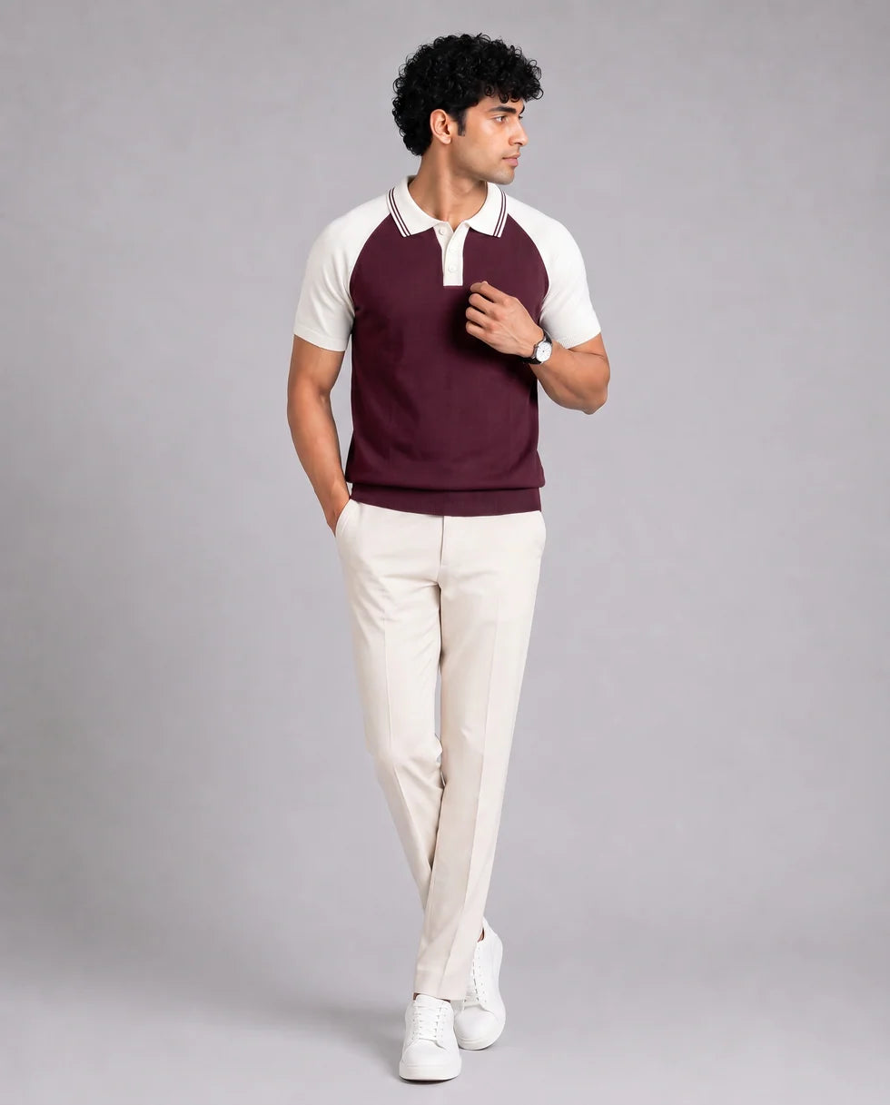 Full-length front view of a model wearing the maroon and white colourblock knit polo