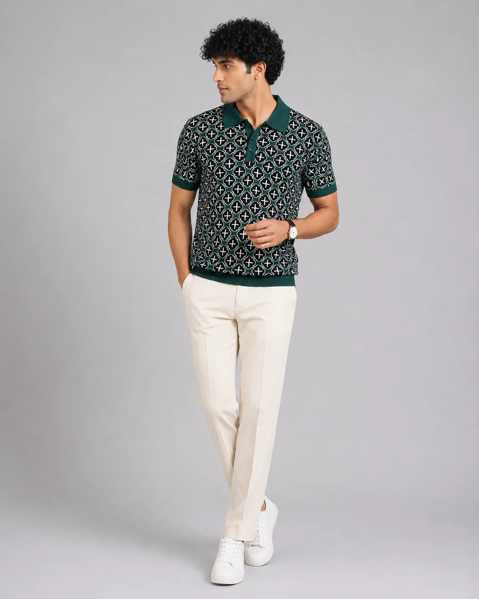 Full-length front view of a model wearing the deep teal green and white mosaic geometric jacquard polo
