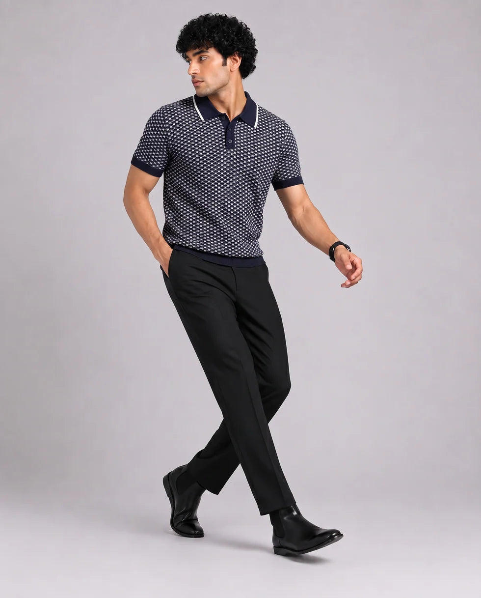 Full-length front view of the navy and white small-scale geometric jacquard polo
