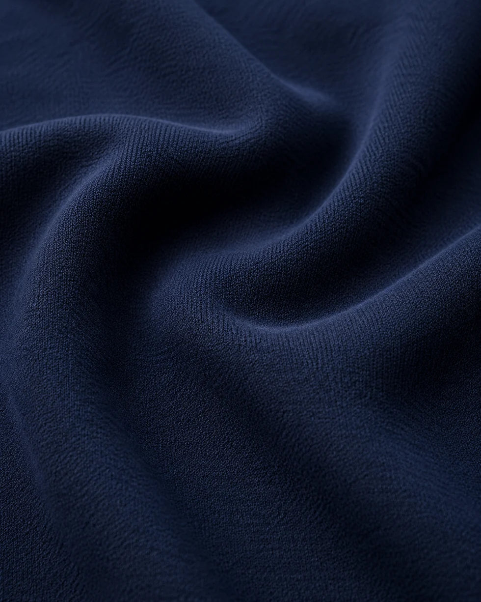 Close-up of the navy and white polo knit texture and horizontal contrast piping