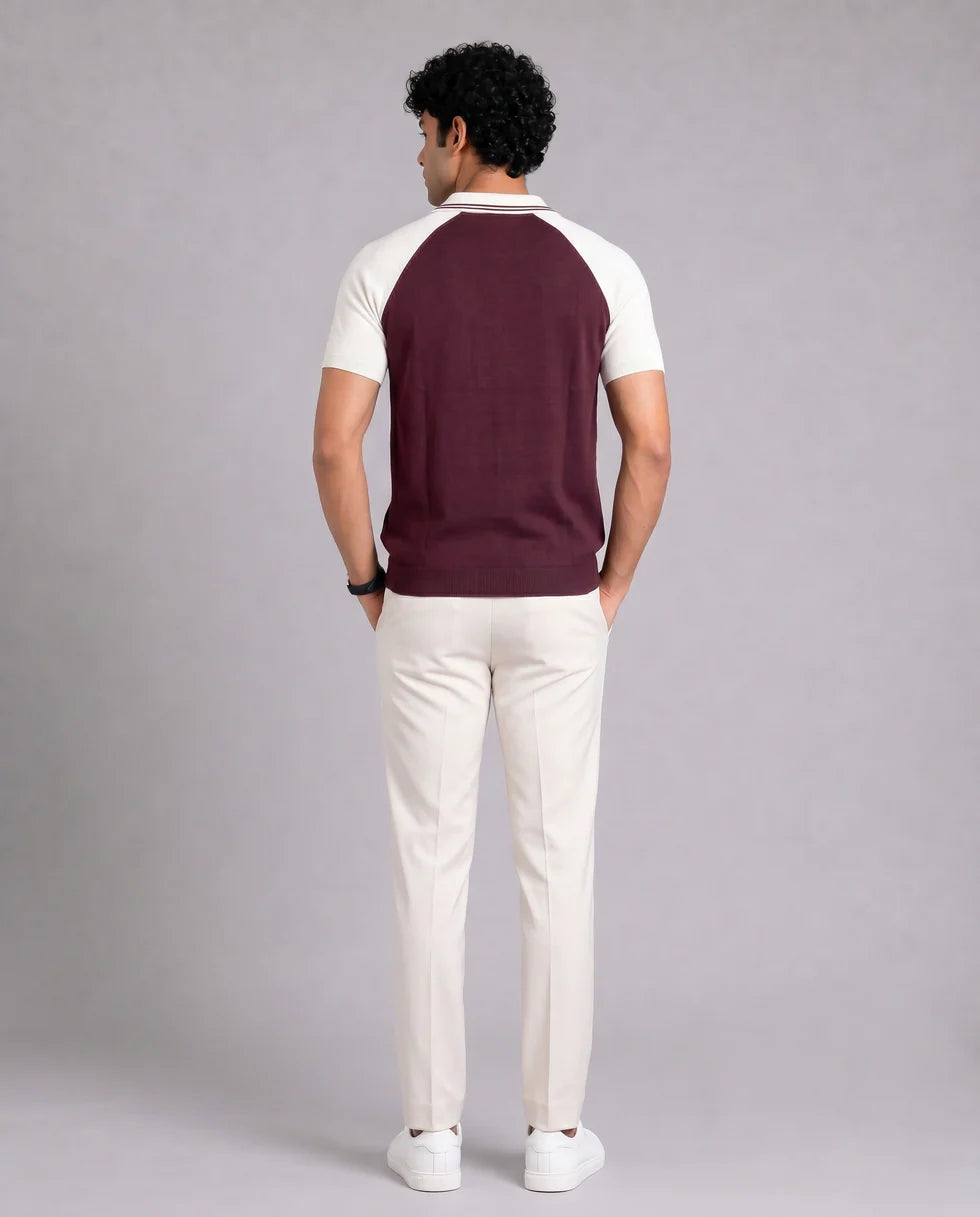 Back view of the maroon and white raglan polo showing its colourblock knit and short sleeves
