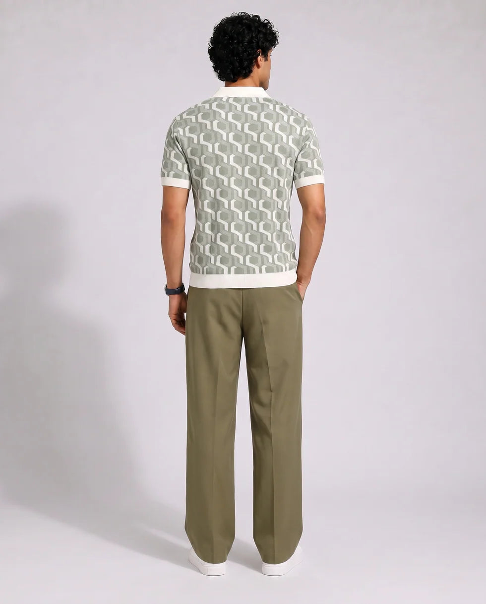 Back view of the sage green and off-white interlocking geometric jacquard polo and its short sleeves