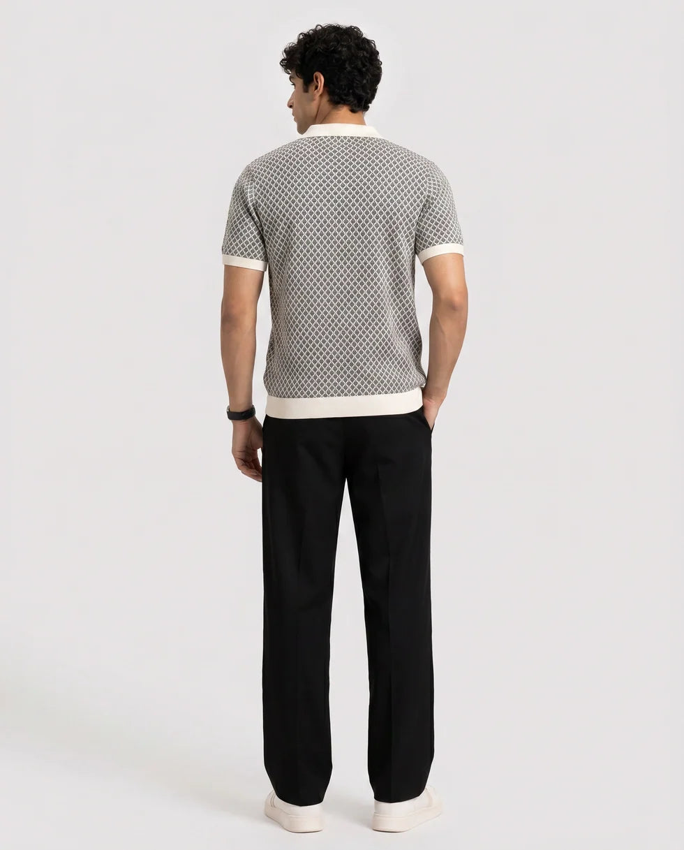 Back view of the black and white diamond jacquard polo and its short sleeves