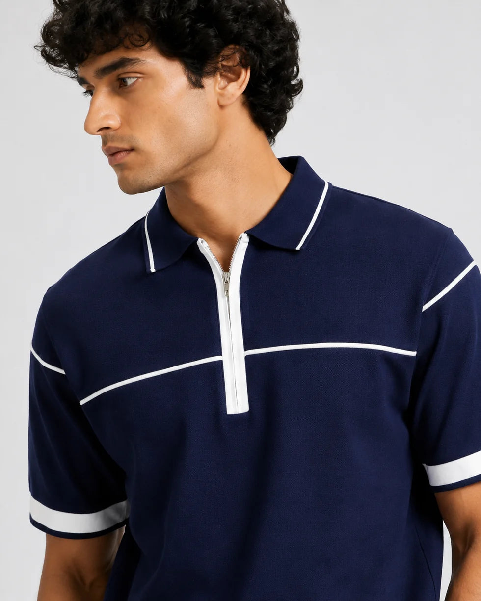 Close front view of the navy and white horizontal contrast piping polo showing its polo collar with zip placket