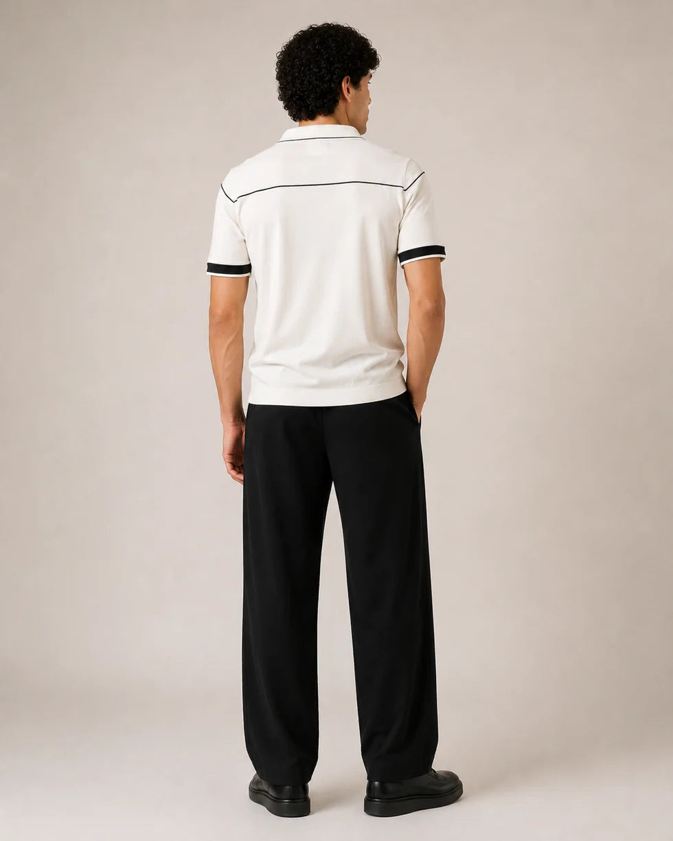 Back view of the off-white knit polo showing green yoke piping and trimmed short sleeves