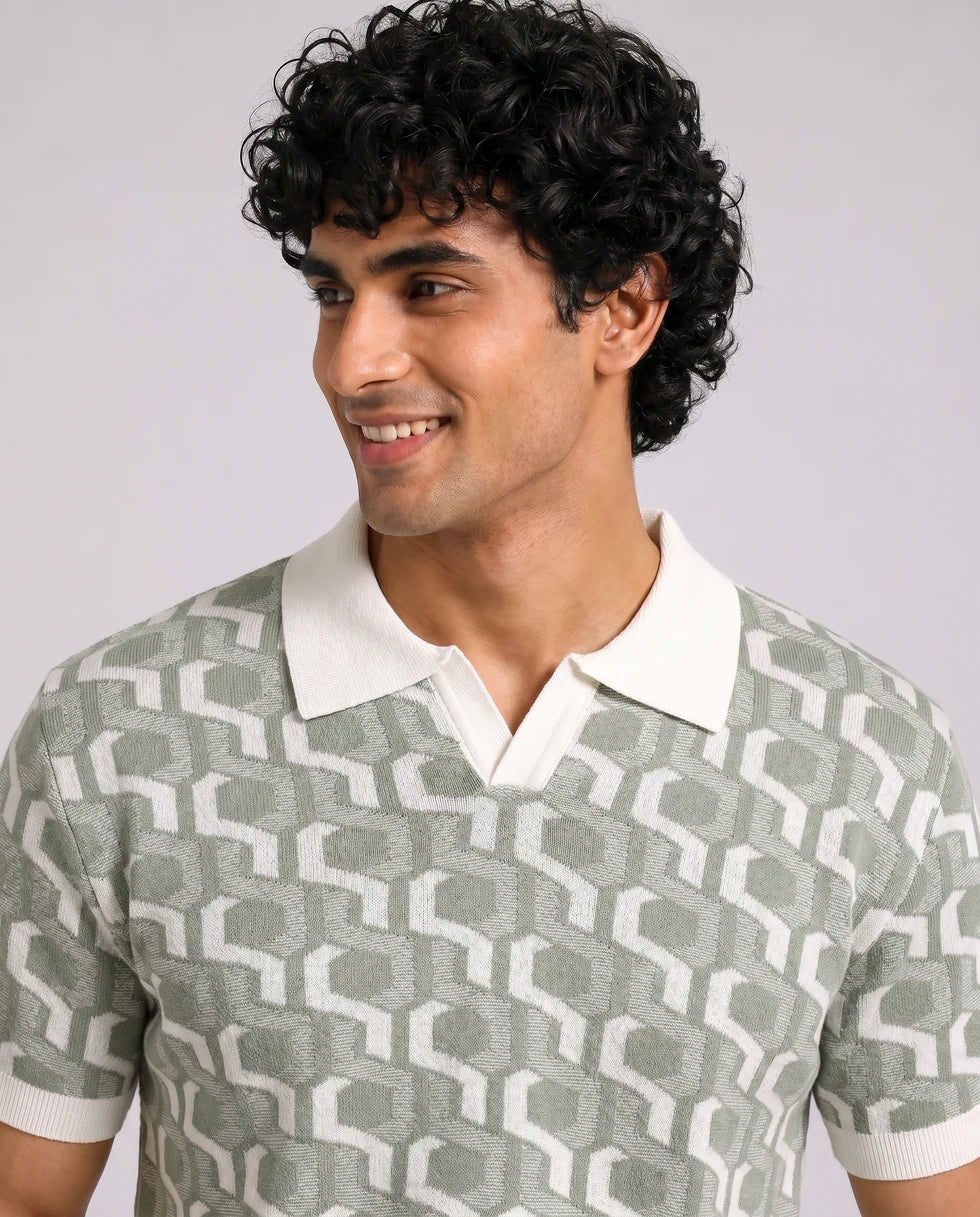 Close front view of the sage green and off-white interlocking geometric jacquard polo showing its open johnny collar