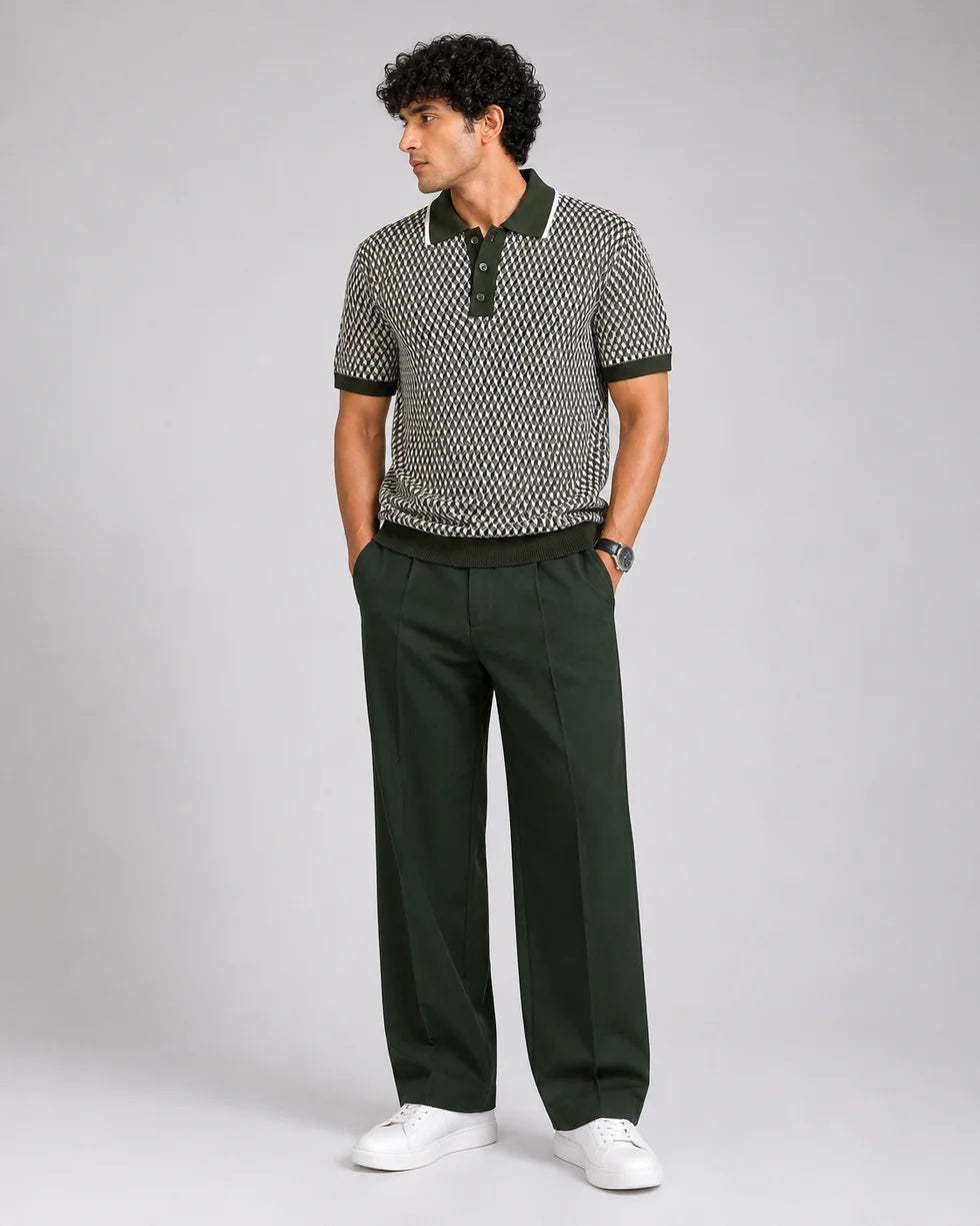 Full-length front view of a model wearing the olive green and cream geometric cube jacquard polo