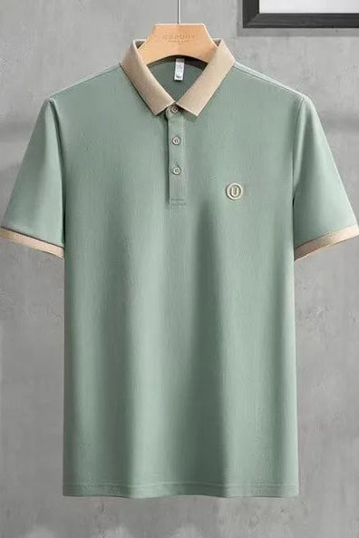 Green polo shirt with beige collar on a gray background